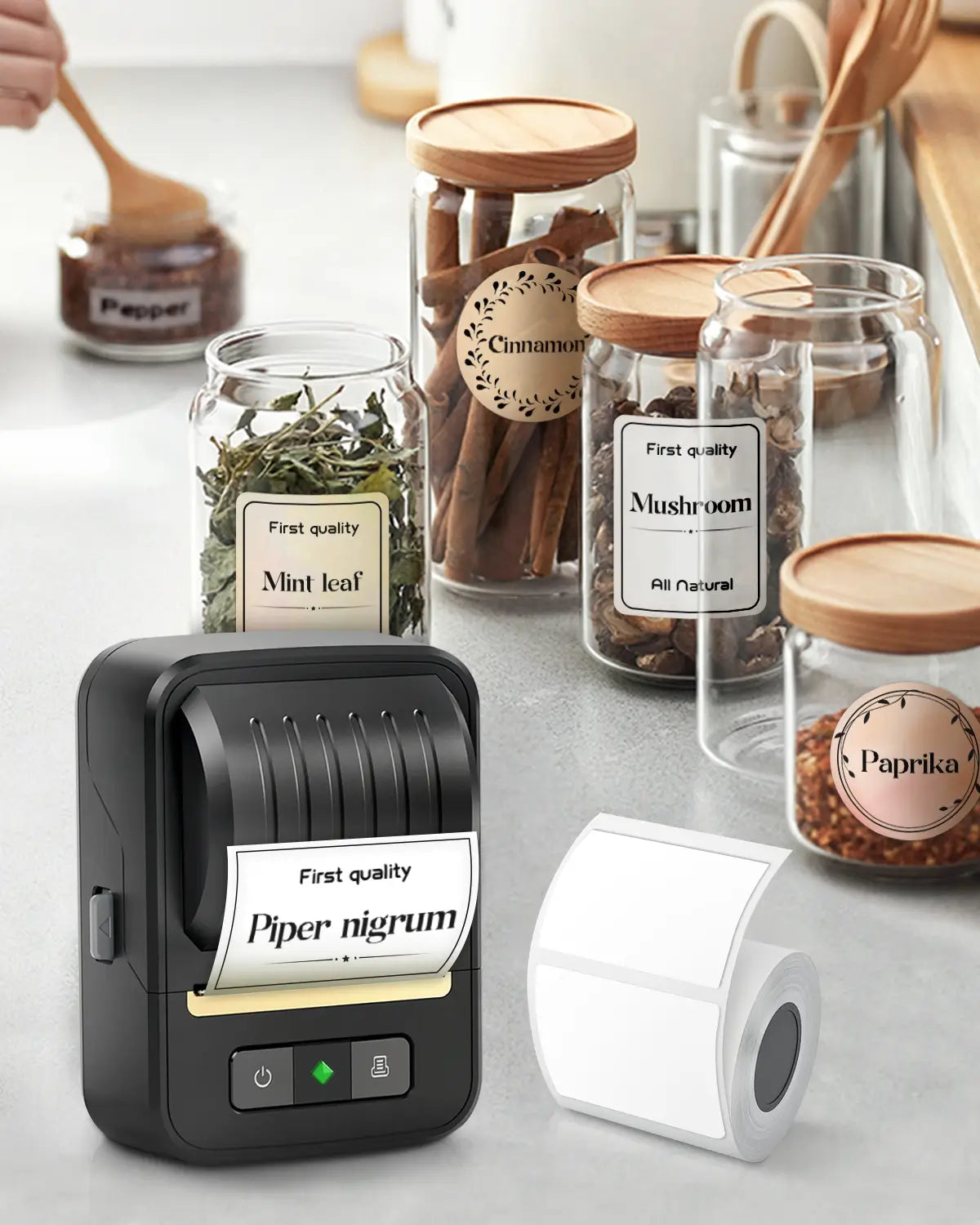 The ndyin Bluetooth portable label maker, with a roll of blank labels, prints kitchen spice & ingredient labels for glass jars.
